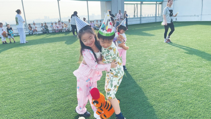Two children hugging each other in a team-building game