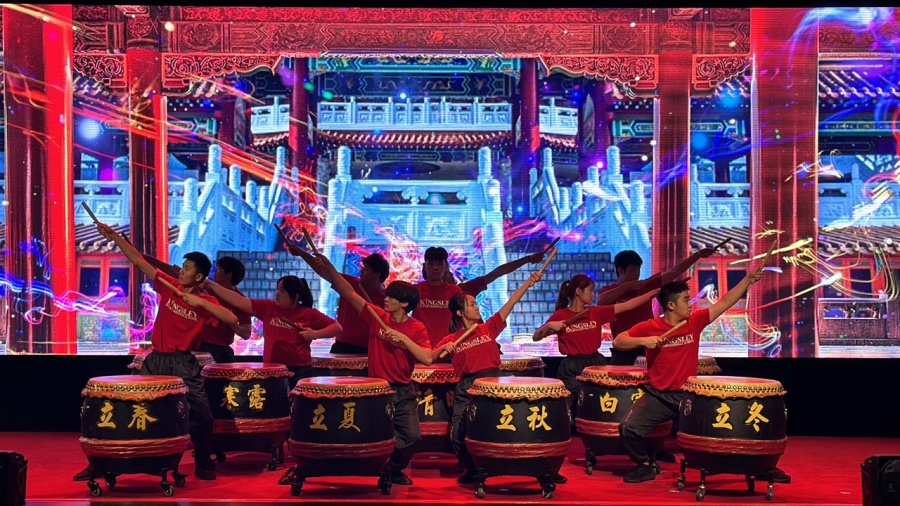 A drumming troupe consisting of Kingsley students post with the 27 drums